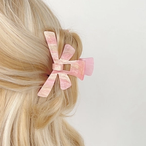 Pink marble texture butterfly hair claw clip for women on blonde hair for elegant styling