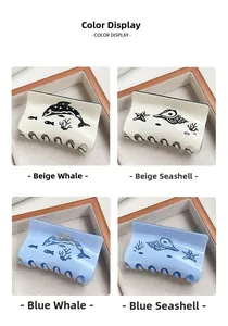 Detailed close-up of ocean-themed whale and conch acetate hair claws in blue and beige