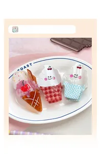 Close-up of cute cartoon ice cream hair claw clips with cherry and smile details