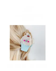 Detail of a cream and blue checkered ice cream hair claw clip on blonde hair