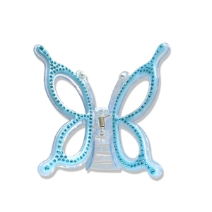 Blue translucent butterfly hair claw clip with blue rhinestones and pearls on white background