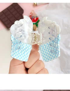 Detailed view of the ice cream shaped hair claw featuring a blue checkered cone design