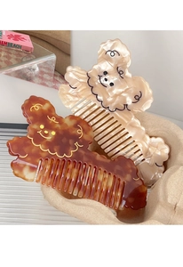 Close-up of cute cartoon bear acetate hair combs in pearl white and tortoiseshell patterns