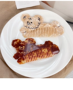 Detail of cute bear-shaped hair combs in cream acetate and tortoiseshell finish
