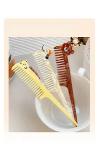 Detailed view of cartoon animal long handle combs in giraffe, puppy and bear designs