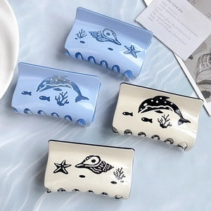 Ocean series acetate hair claws featuring blue whale and shell patterns in a 4-piece set