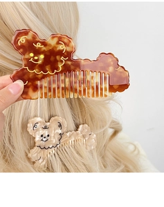 Detail showing cartoon bear acetic acid hair combs set on blonde wavy hair background