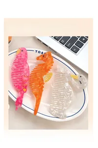 Detail of acetate hair clips featuring colorful parrot, seahorse, and swan animal shapes