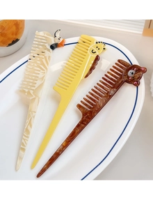 Detailed view of three cartoon animal tail combs with bear and giraffe acetate patterns