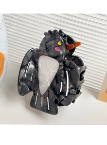 Detailed top view of a unique owl-shaped hair claw clip with black marble finish and orange beak