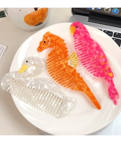Detail of colorful acetate animal shaped hair combs with marble texture in a set