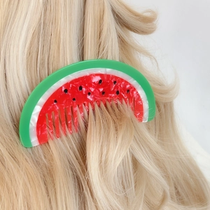 Watermelon hair comb in red and green acetate, styled on long blonde wavy hair