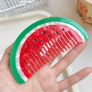 Watermelon shaped acetate hair comb with vibrant red and green colors for kids