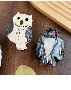 Close-up of owl and bird hair claws made of premium marble texture acetate material
