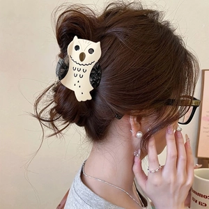 Cute cartoon owl hair claw clip in beige acetate for women, back view of messy bun styling