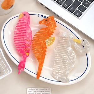 Chic cartoon swan and seahorse acetate hair combs with marble texture in a home setting