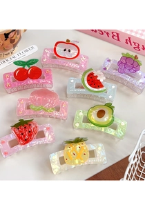 Detail view of colorful acrylic fruit hair claws featuring cute strawberry and cherry patterns