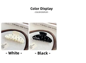 Detailed close-up of large hair claw clips featuring sparkling rhinestones in black and cream