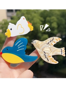 Detailed view of three cute acetate hair clips with bird and duck designs for women