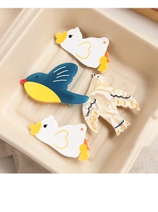Close-up of acetic acid bird-shaped hair clips in ducks and pigeons patterns
