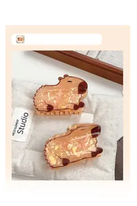 Detailed close-up of cute Capybara hair claw clips with acetate pearlescent texture
