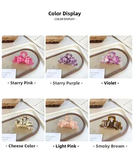 Detail view of acetate bow hair clips in six elegant colors on a decorative tray