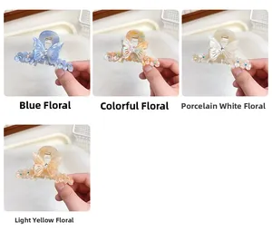 Détails des pinces à cheveux papillon en acétate avec motifs floraux et strass brillants