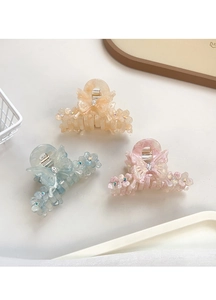 Détail de trois pinces à cheveux papillon en acétate avec cristaux aux tons pastel doux