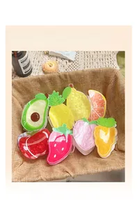 Variety of cute fruit and vegetable hair claws including avocado and peach in a basket