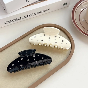 Elegant rhinestone-studded hair claws in black and cream white for stylish updos