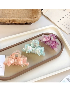 Three elegant marble textured acetate bow hair claws in pink, mint green and purple colors