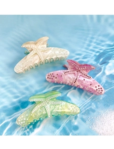 Macro detail of large acrylic starfish claw clips with pearl and rhinestone accents