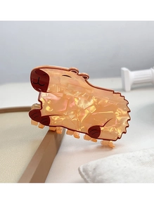 Detail view of cute Capybara hair claw clip with shimmering pearlescent orange texture