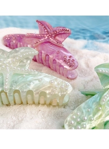 Detail of starfish hair claw clip with pearls, rhinestones and marble texture