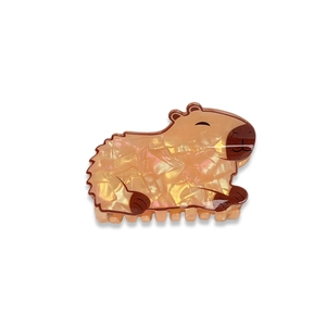 Cute capybara hair claw clip with orange pearlescent finish for women's hairstyling