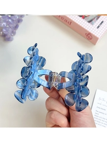 Detail of blue marble cellulose acetate hair claw clip with strong metal spring