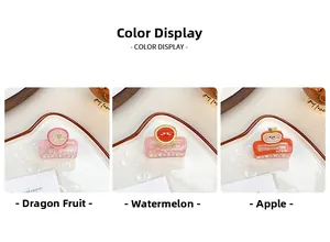 Close-up of cute fruit-themed hair claws featuring dragon fruit, watermelon and apple patterns
