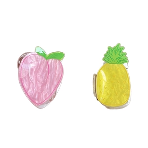 Cute acrylic fruit hair claws featuring peach and pineapple designs with marble texture
