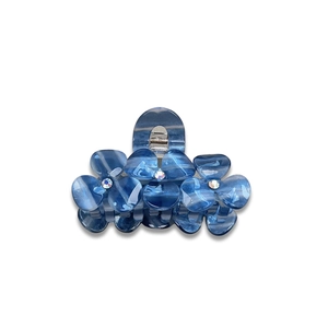 Blue acetate floral hair claw clip with marble texture and sparkling rhinestone centers