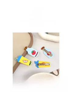 Macro detail of cartoon hair clips with tomato and lemon patterns and gold alloy clamps