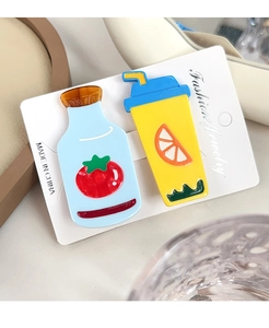 Detail of acrylic hair clips featuring cute tomato milk bottle and lemon tea cup designs
