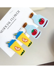Detailed view of four-piece fruit-themed acrylic hair clips on a white display card