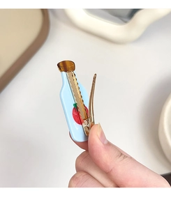 Detailed back view of a blue milk bottle hair clip with a sturdy gold metal duckbill clip