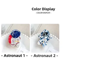 Detail view of two cartoon astronaut hair claws in red-white-blue and marble blue colors