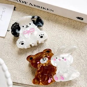 Detailed close-up of acetate animal hair claws featuring dog bear and rabbit shapes