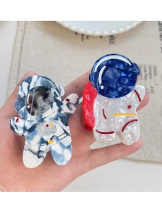 Macro detail of two astronaut hair claws made of marble blue and pearl white acetate