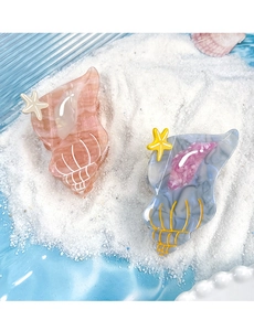 Close-up of acetic acid seashell hair claws in pink and blue with starfish details