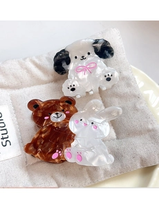 Close-up of acetate animal hair claws featuring cute bear, rabbit and puppy designs
