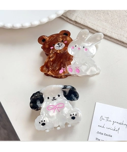 Detail of cute acetate animal hair claws featuring brown bear, white rabbit and dog motifs
