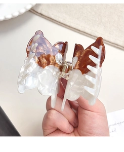 Detail of a large acetate butterfly hair claw clip with brown tortoiseshell and pearl finish
